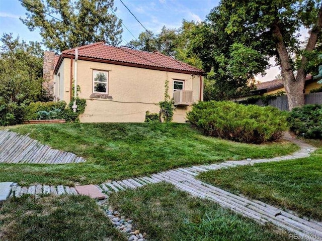 view of side of home featuring a lawn