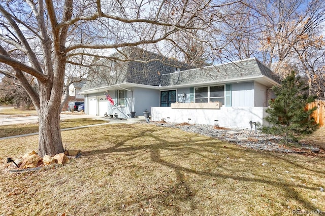 ranch-style home featuring mansard roof, roof with shingles, a front yard, a garage, and driveway