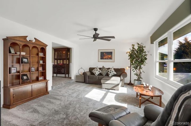 living room with ceiling fan and carpet flooring