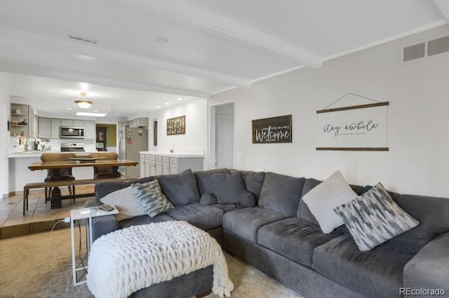 living area with visible vents, recessed lighting, and beam ceiling