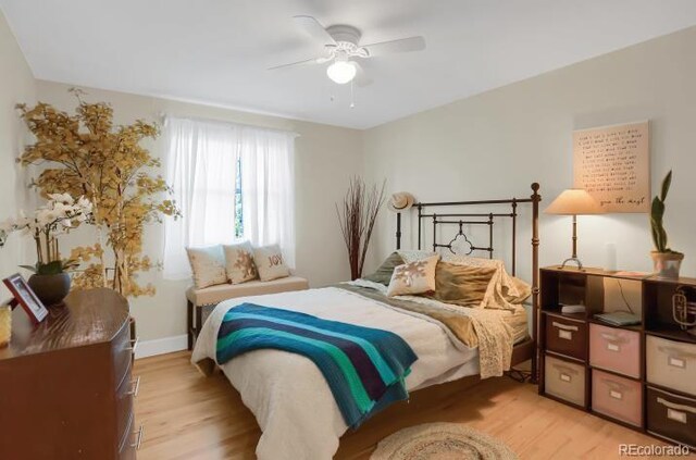 bedroom featuring light wood-type flooring, baseboards, and ceiling fan