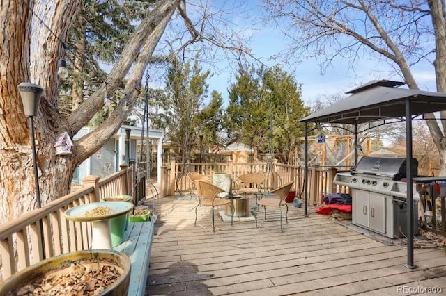 wooden terrace with a grill