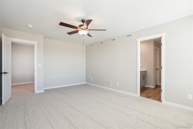 unfurnished bedroom featuring light carpet, baseboards, and visible vents