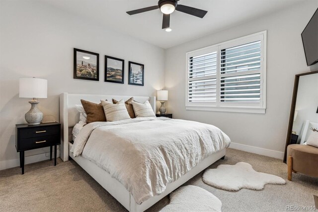 bedroom featuring baseboards, a ceiling fan, and light colored carpet