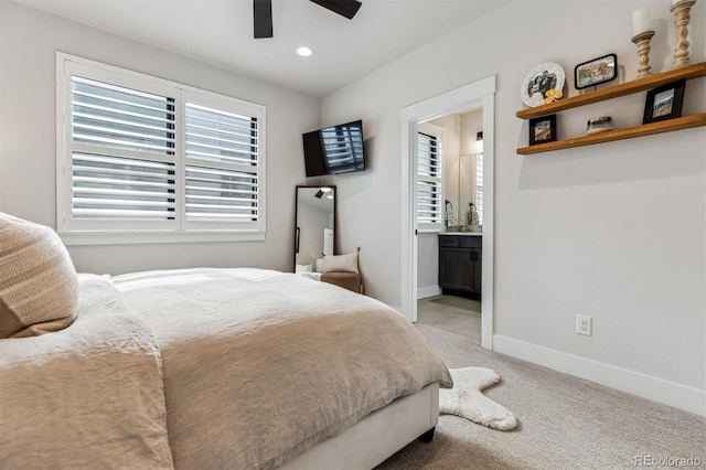 bedroom with recessed lighting, light colored carpet, a ceiling fan, connected bathroom, and baseboards