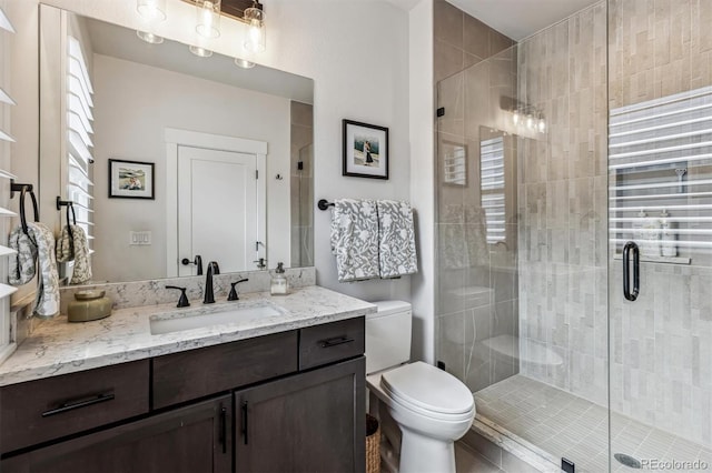 full bath with toilet, a shower stall, and vanity