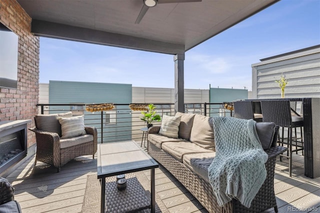 wooden terrace with an outdoor living space