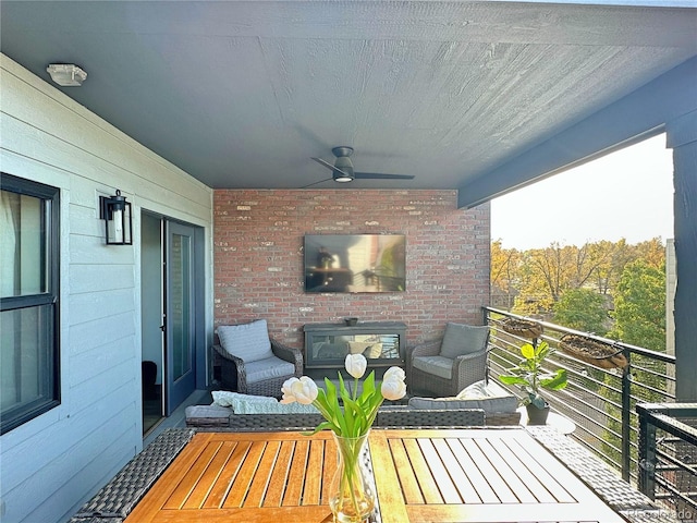 wooden terrace featuring ceiling fan and an outdoor living space