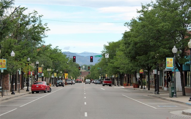 view of street featuring sidewalks, traffic lights, and curbs