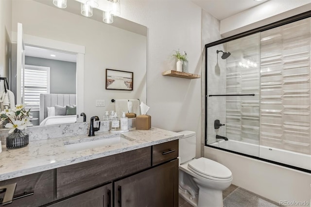5423 S Prince St Unit B, Littleton, CO 80120 - bathroom featuring vanity, enclosed tub / shower combo, and toilet