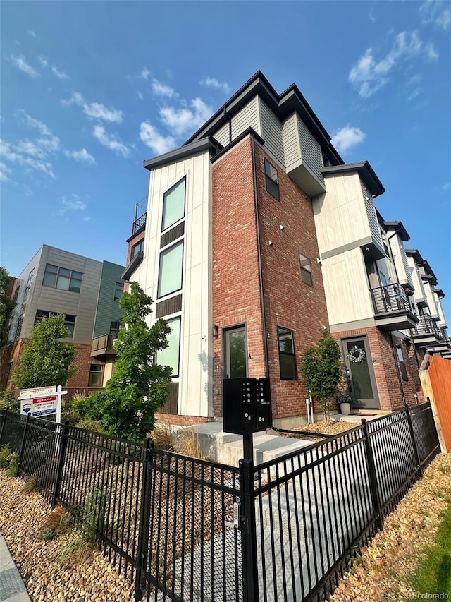 5423 S Prince St Unit B, Littleton, CO 80120 - view of side of property featuring mail area and brick siding