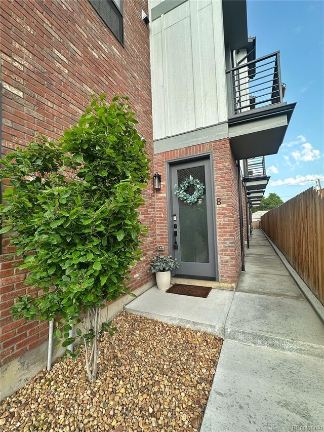 5423 S Prince St Unit B, Littleton, CO 80120 - entrance to property featuring a balcony and brick siding