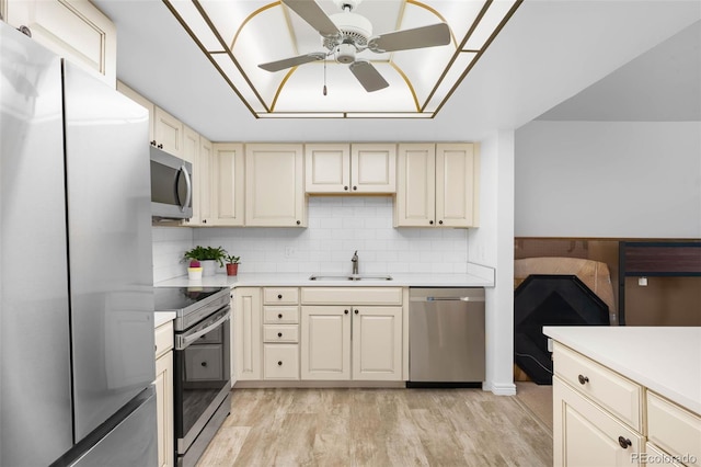 14300 E Marina Dr Unit 306, Aurora, CO 80014 - kitchen with stainless steel appliances, cream cabinetry, a ceiling fan, light countertops, and light wood-style flooring