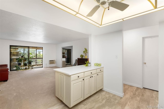 14300 E Marina Dr Unit 306, Aurora, CO 80014 - kitchen with ceiling fan, light countertops, open floor plan, a wall mounted AC, and a peninsula