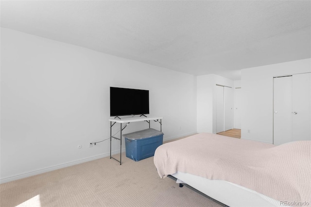 14300 E Marina Dr Unit 306, Aurora, CO 80014 - bedroom with light carpet and multiple closets