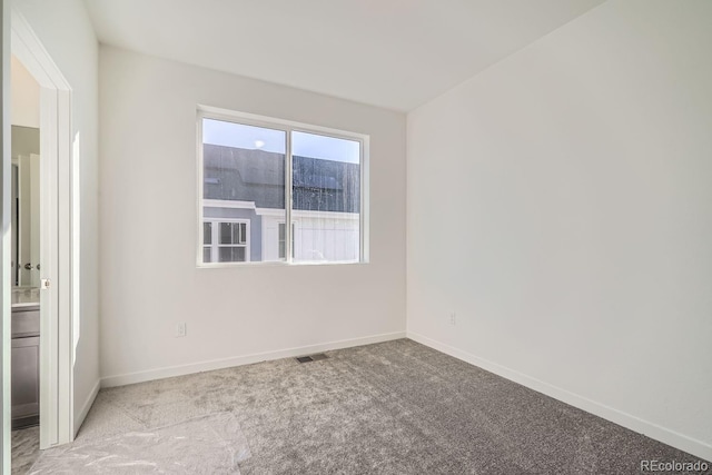 unfurnished room with light colored carpet