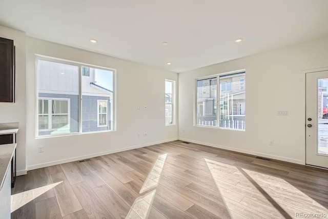 unfurnished living room with light hardwood / wood-style flooring