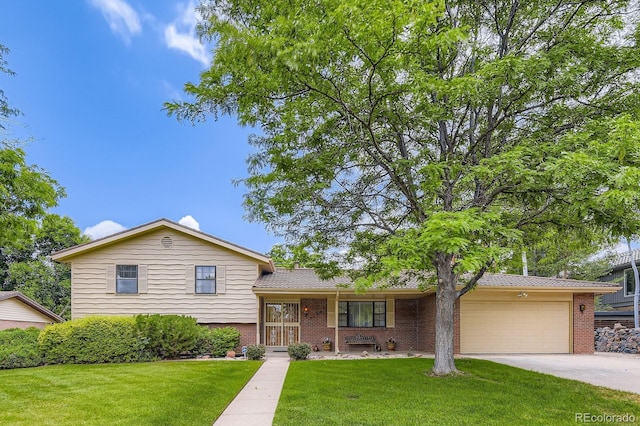 3724 S Poplar St, Denver, CO 80237 - split level home featuring brick siding, a front lawn, a garage, and driveway
