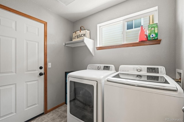 laundry room featuring separate washer and dryer and baseboards