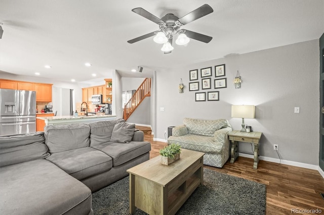 living area featuring wood finished floors, stairway, a ceiling fan, baseboards, and recessed lighting