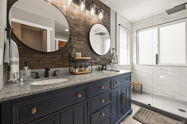 full bathroom featuring double vanity and a stall shower