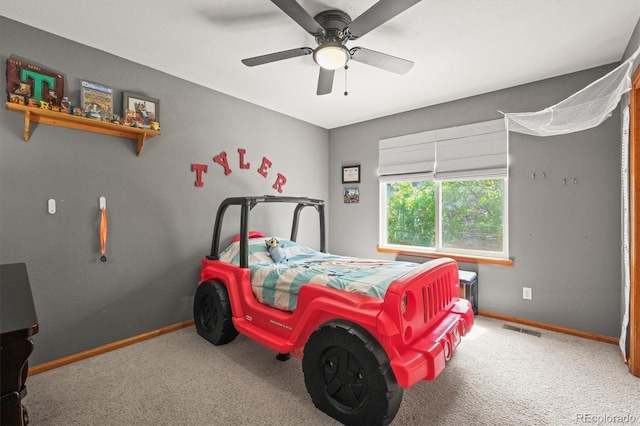 carpeted bedroom featuring baseboards and a ceiling fan
