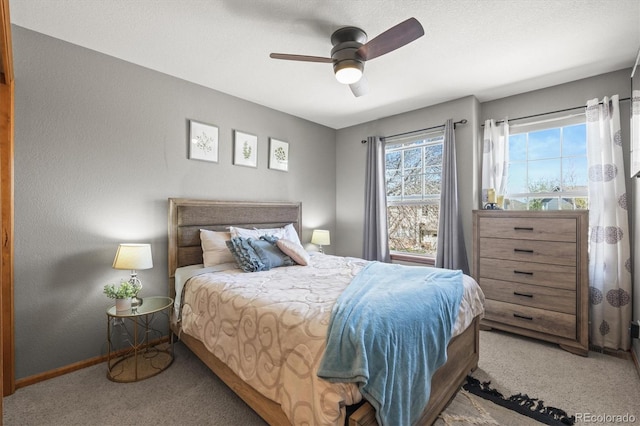 bedroom with carpet, baseboards, and a ceiling fan