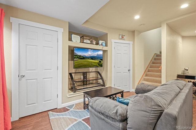 living area featuring stairs, wood finished floors, recessed lighting, and baseboards