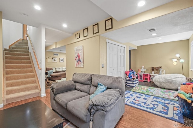 living room with stairs, wood finished floors, and recessed lighting