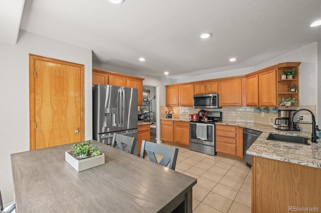 kitchen featuring appliances with stainless steel finishes, a sink, open shelves, decorative backsplash, and light tile patterned floors
