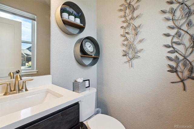 bathroom with vanity and toilet