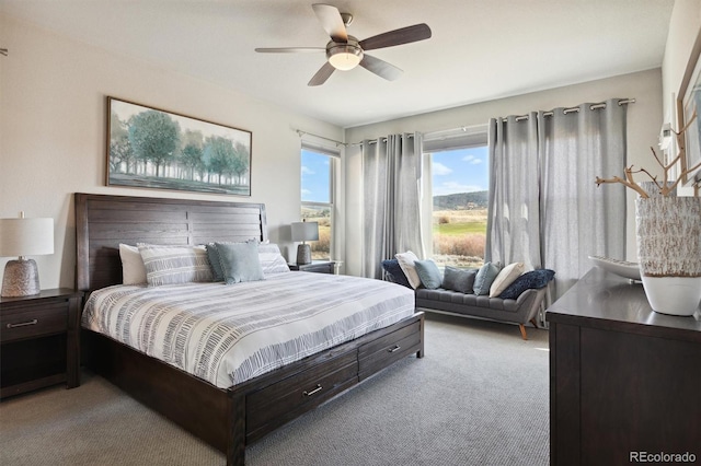 bedroom with ceiling fan and light carpet