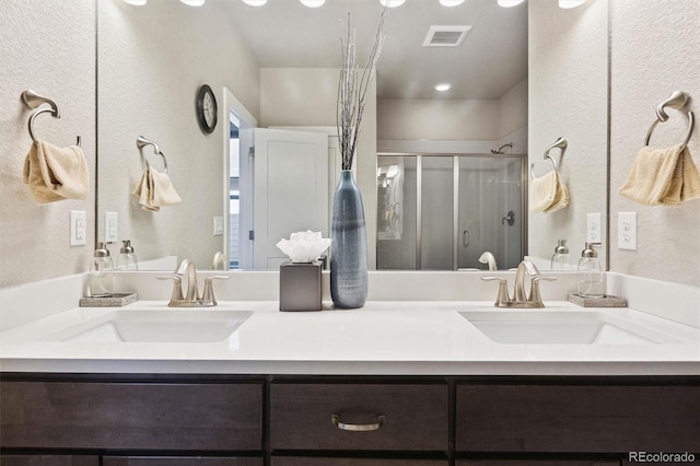 bathroom with vanity and an enclosed shower