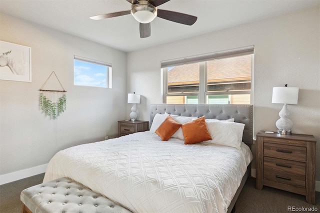 bedroom with ceiling fan and dark carpet