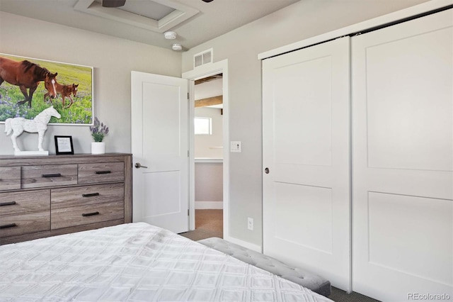 bedroom featuring light carpet and a closet