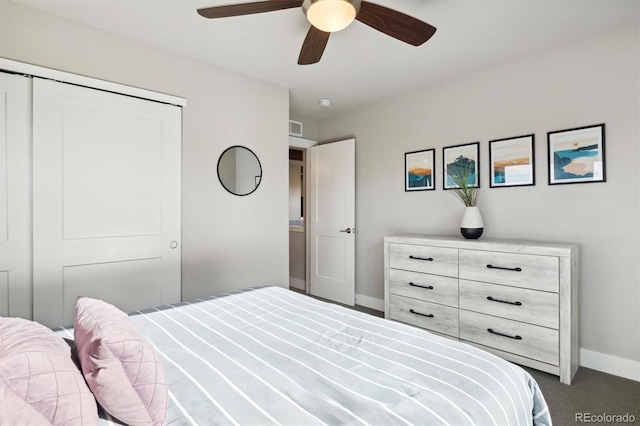 carpeted bedroom featuring a closet and ceiling fan