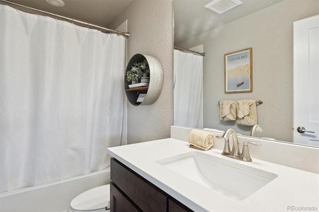 full bathroom with shower / bathtub combination with curtain, vanity, and toilet