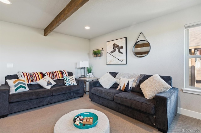 carpeted living room featuring plenty of natural light and beam ceiling