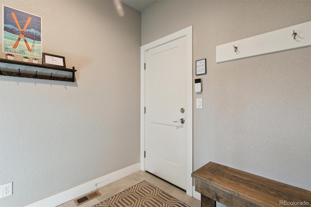 entryway with light tile patterned floors