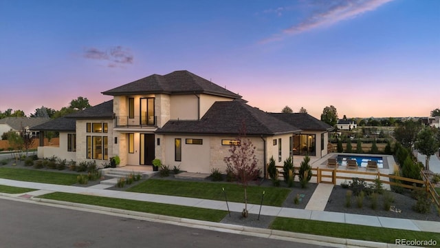 14545 Lipan St, Westminster, CO 80023 - view of front of home with a balcony, stucco siding, and stone siding