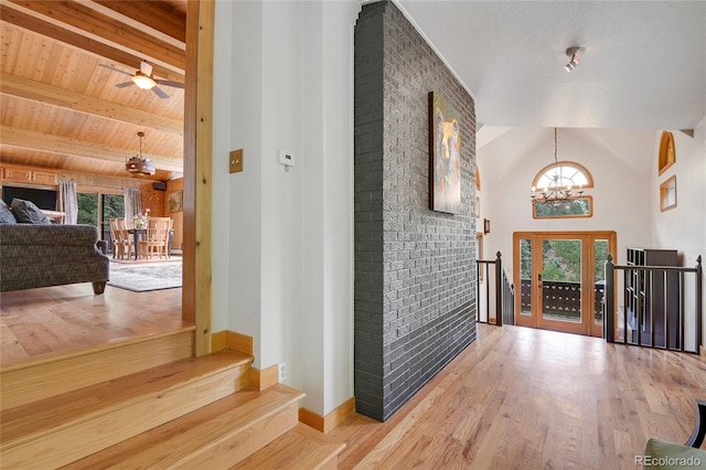 foyer with a wealth of natural light, wood ceiling, and light wood-type flooring