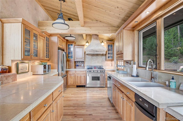 kitchen with stainless steel appliances, pendant lighting, premium range hood, light wood-type flooring, and wooden ceiling