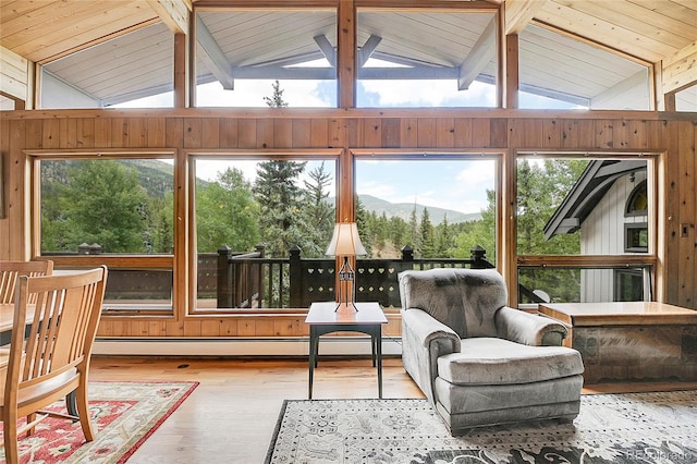 sunroom featuring a baseboard heating unit, a healthy amount of sunlight, vaulted ceiling with beams, and wooden ceiling