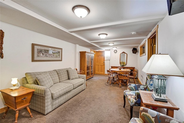 carpeted living room featuring beamed ceiling