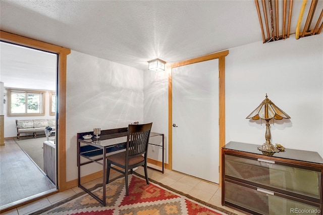 office area featuring a textured ceiling and light tile patterned floors