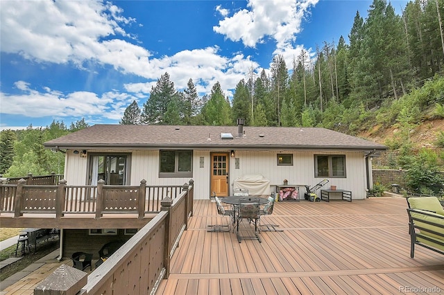 back of property featuring a wooden deck