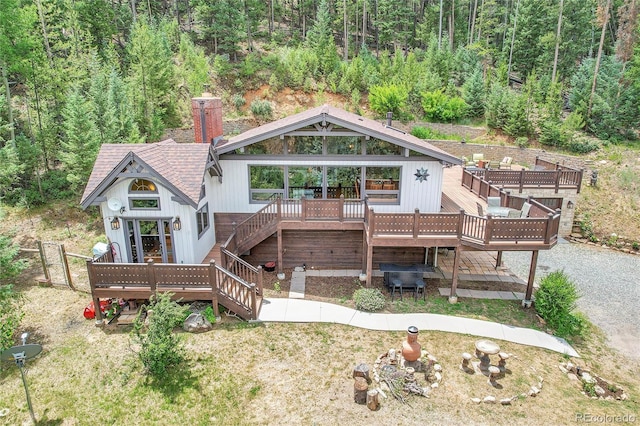 1774 Upper Bear Creek Rd, Evergreen, CO 80439 - back of property featuring a deck, stairway, roof with shingles, and a forest view