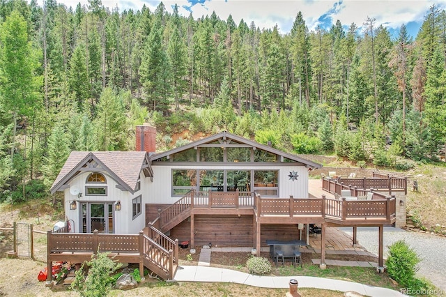 1774 Upper Bear Creek Rd, Evergreen, CO 80439 - back of house with a wooden deck, stairs, and a forest view
