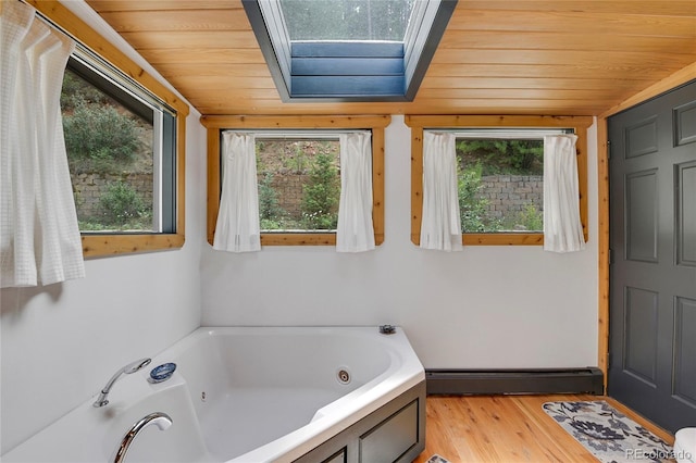 1774 Upper Bear Creek Rd, Evergreen, CO 80439 - bathroom featuring baseboard heating, wood ceiling, healthy amount of natural light, a tub with jets, and wood finished floors