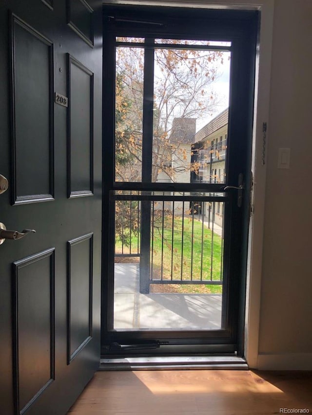 5875 E Iliff Ave Unit 203, Denver, CO 80222 - doorway to outside featuring wood finished floors